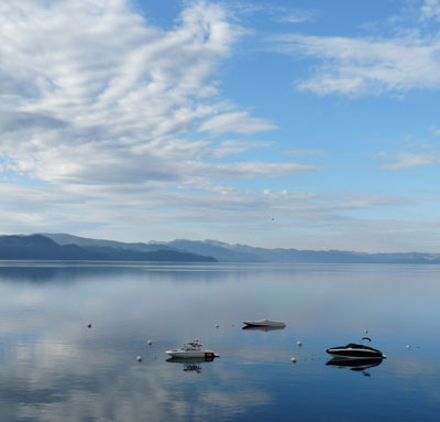 lake with little boats and clouds